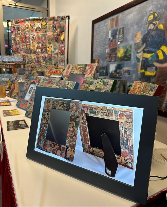 Comic-panel picture frames on a display table, with a framed collection shown in front.