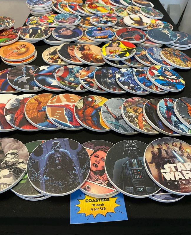 Rows of round coasters decorated with comic-book superheroes and Star Wars characters.